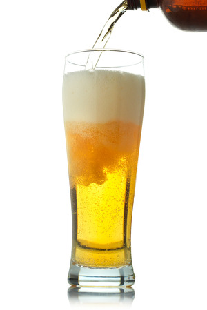 Pouring beer into glass の写真素材