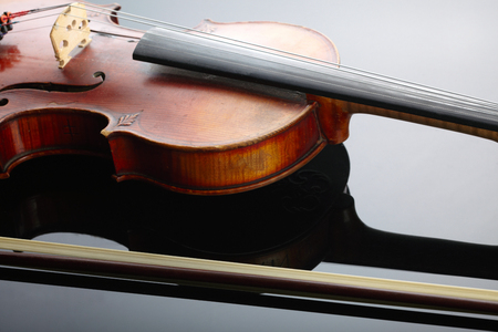 Violin and bow on dark backgroundの写真素材
