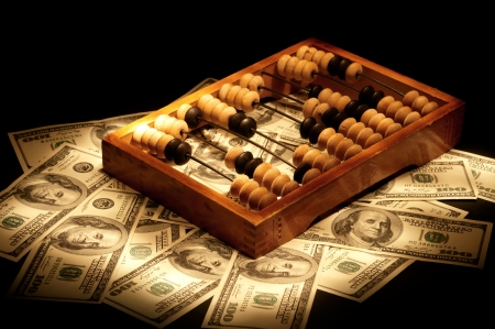 Old abacus on dollars and euro backgroundの写真素材