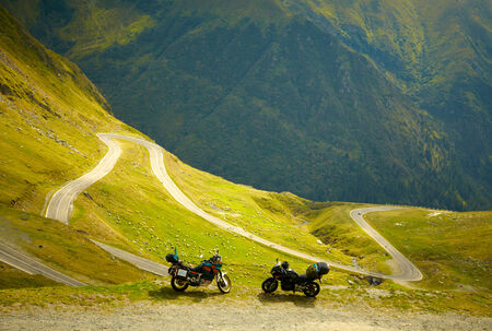Landscape with mountain road and two motorbikesの写真素材