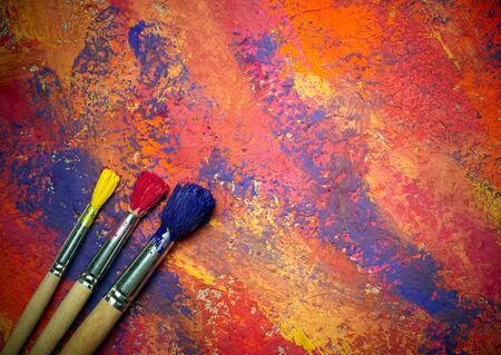 Paintbrushes on abstract grange backgroundの写真素材