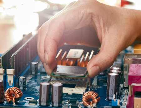 Engineer plug in CPU microprocessor to motherboard socketの写真素材