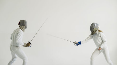 Two fencers have fencing training on white backgroundの写真素材
