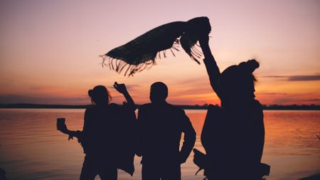 Silhouette of Group young dancing people have a party at beach on sunsetの写真素材