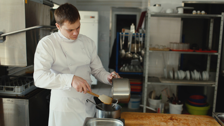 Professional chef man prepare gravy sauce with spices at restaurant kitchenの写真素材