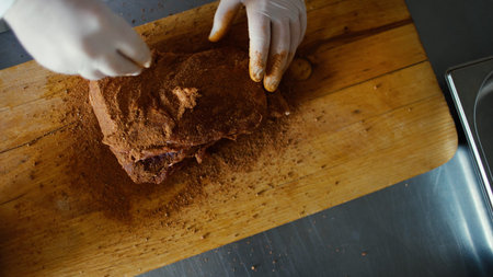 Closeup of professional chef man prepare meat with spice on cutting board at restaurant kitchen