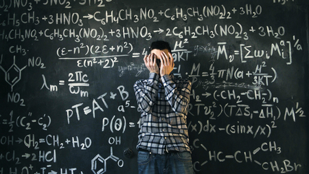scientist man disappointed about problems experiment in chemical and mathematical equations roomの写真素材