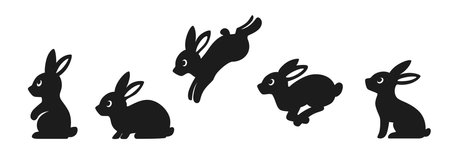 Set of sitting and jumping silhouettes of rabbits. Cute black bunnies.のイラスト素材