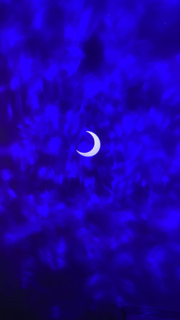 The moon in the night sky. Blue background. The moon in the night sky.