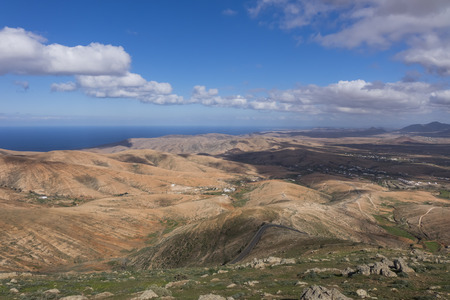 View across the  distant mountains with the sea in the distance in  Fuerteventura Canary islands Las palmas Spainの写真素材