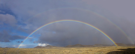 Dramatic Rainbow with mountains in the background in  Fuerteventura Canary islands Las palmas Spainの写真素材