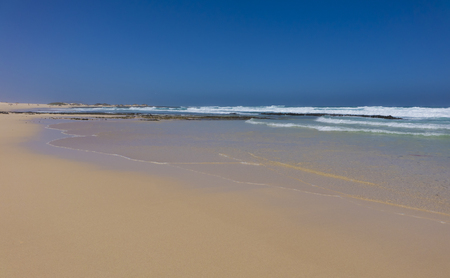 Golden sand under a blue sky on Corralejo beach in Canary islands, Spainの写真素材