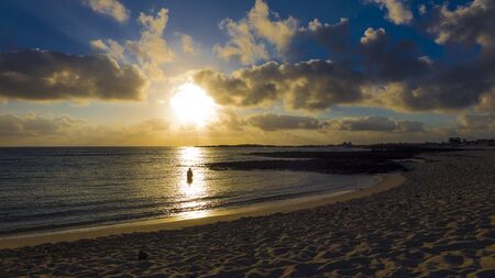 Sunset with dramatic colourful colorful sky in El Cotillo Fuerteventura Canary Islands Spainの写真素材