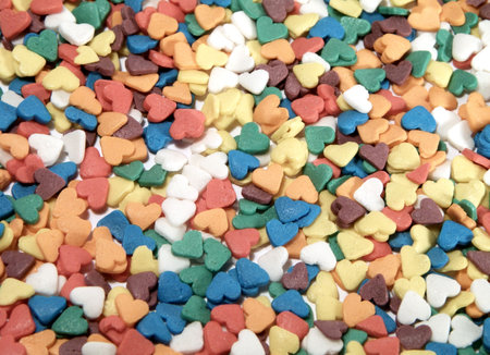 Colorful candy background in the form of hearts