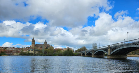 Horizontal photograph of the banks of the Tormes river, in the distance the complex of Cathedrals. Image taken in Salamanca, Castilla y Leon, Spain.の写真素材