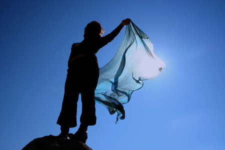 silhouette of a woman in blue skyの写真素材