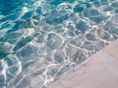 abstract background with blue water and stairs of the swimming pool の写真素材