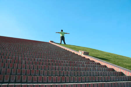 boy in top of a stairs with open arms - symbol of freedomの写真素材