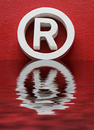 R trademark and reflection in red backgroundの写真素材