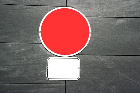 two empty signs in textured granite wall の写真素材