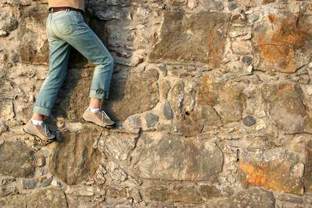 detail from woman climbing textured granite wallの写真素材