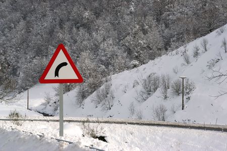 danger right turn traffic in sonw covered road - winter landscapeの写真素材