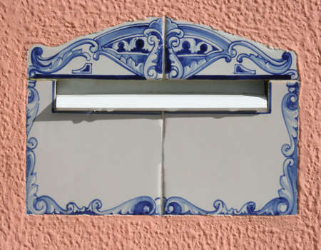 painted tiles in Portugal, typical mail box in a pink wallの写真素材