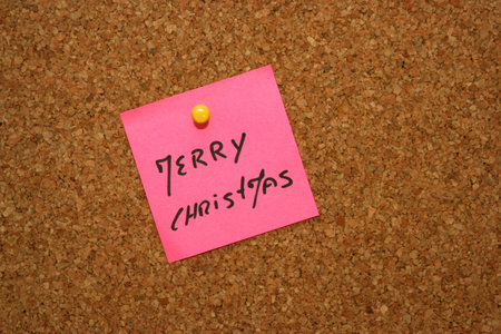 cork board with pink note 