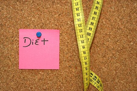 Diet note and metric tape in cork boardの写真素材