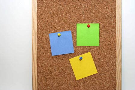 cork board in white background, with colored notesの写真素材