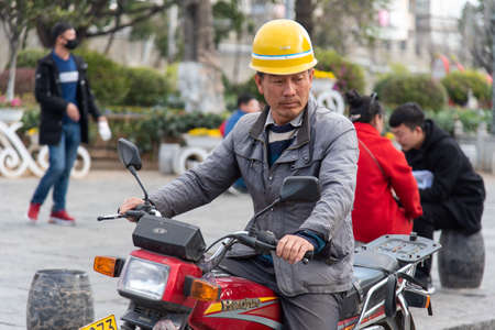 DALI, CHINA. February 2019. Person driving his own means of transportのeditorial素材