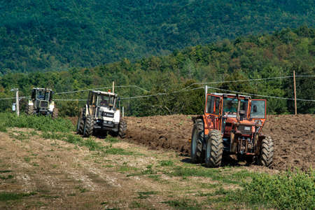 September 2020, Calestano province of Parma, Italy. Three tractors plowing a field. Same galaxy 170. Hurlimann h 6170 t.のeditorial素材