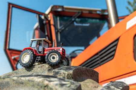 September 2020, Calestano province of Parma, Italy. Vintage model of same galaxy 170 tractor. Alongside the real tractorのeditorial素材