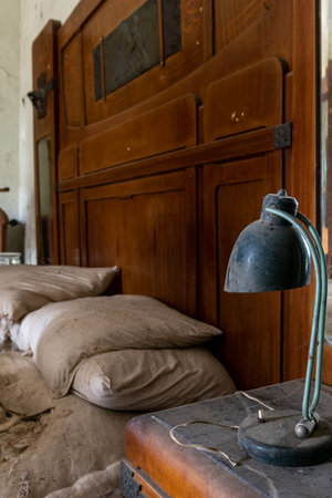 Italy, January 20, 2021. Bedside table in a bedroom of an abandoned country villaのeditorial素材
