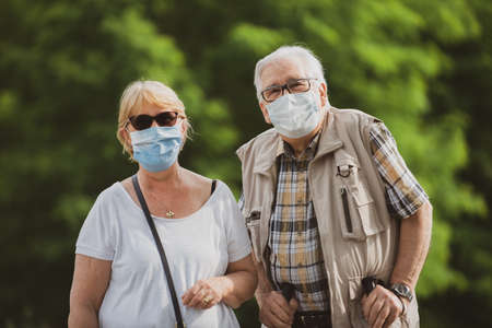 20 October 2020, Italy. Elderly people walk with masks on a country roadのeditorial素材