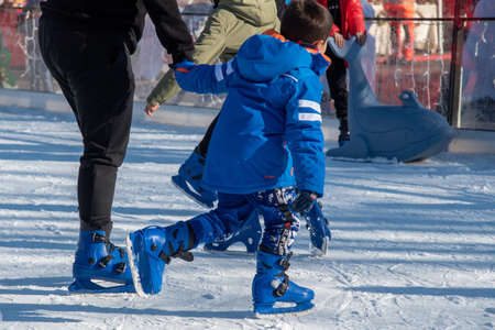 Bibbiano, December 2021. Young people skate on a small rink in the town squareのeditorial素材