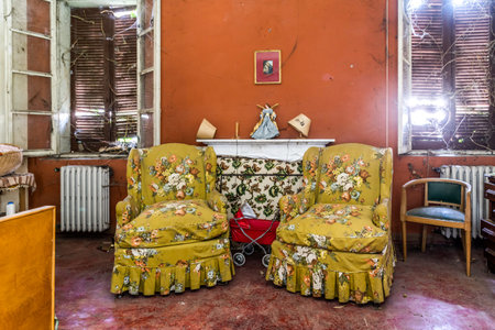 February 2022, bedroom with fireplace and armchairs in perfect condition in an abandoned house, Urbex In northern Italy. Urban explorationのeditorial素材