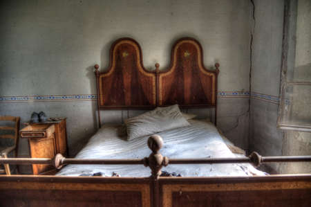 Italy, September 2022. Bedroom of an abandoned houseの写真素材