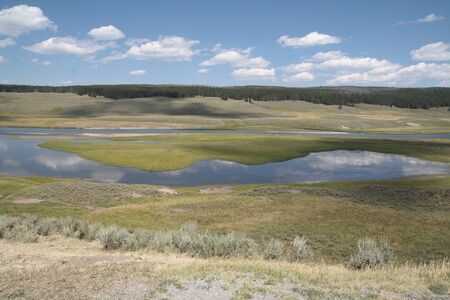 Hayden Valley in Yellowstone National Park with blue sky reflectionの写真素材