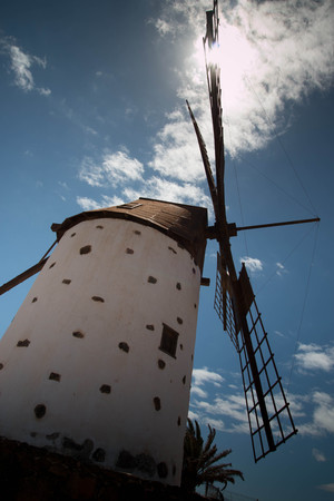 Windmill with blue sky background, Backlit vertical shot. Low angle view. Lanzarote, Spain.の写真素材