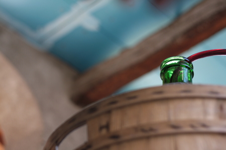 Siphoning wine into a demijohn, carboy. Wallpaper, background. With copy space.の写真素材