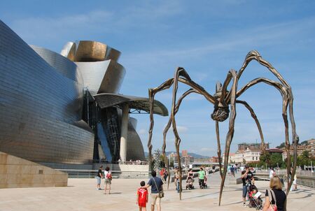Front view of the Guggenheim Museum of Bilbao with the spider sculpture "Maman" by artist Louise Bourgeois, located on the Nervi?n river.のeditorial素材