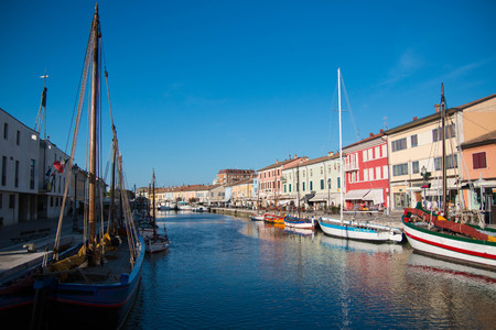 View of Porto Canale, the central canal in the beautiful town of cesenatico, on the adriatic coast in italy, with the traditional painted sailboats that are part of the marine museum.のeditorial素材