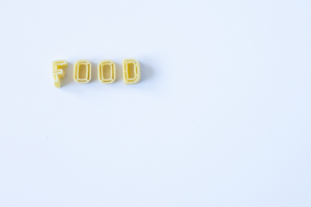 The word "food" written with pasta on a white backgroundの写真素材