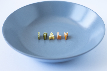 The word "Italy" written with pasta in a blue dishの写真素材