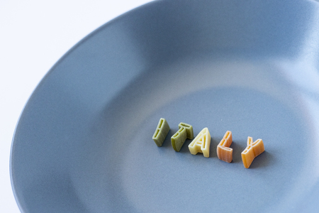 The word "Italy" written with pasta in a blue dishの写真素材