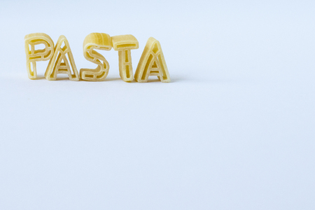 the word pasta written with real pasta letters on a blank background.の写真素材