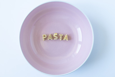 the word "pasta" written with pasta in a pink dishの写真素材