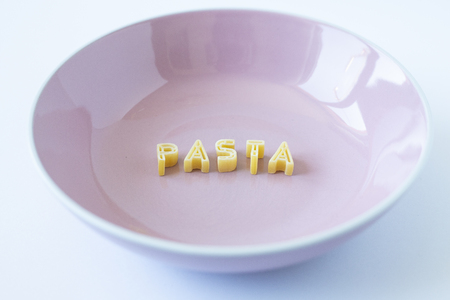 the word "pasta" written with pasta in a pink dishの写真素材
