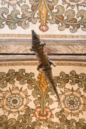 Crocodile hanging from the ceiling in the Sanctuary of Santa Maria delle Grazie, Curtatone, Province of Mantua, Italy. The stuffed animal is supposed to be 600 years old. Right below view. Vertical.のeditorial素材